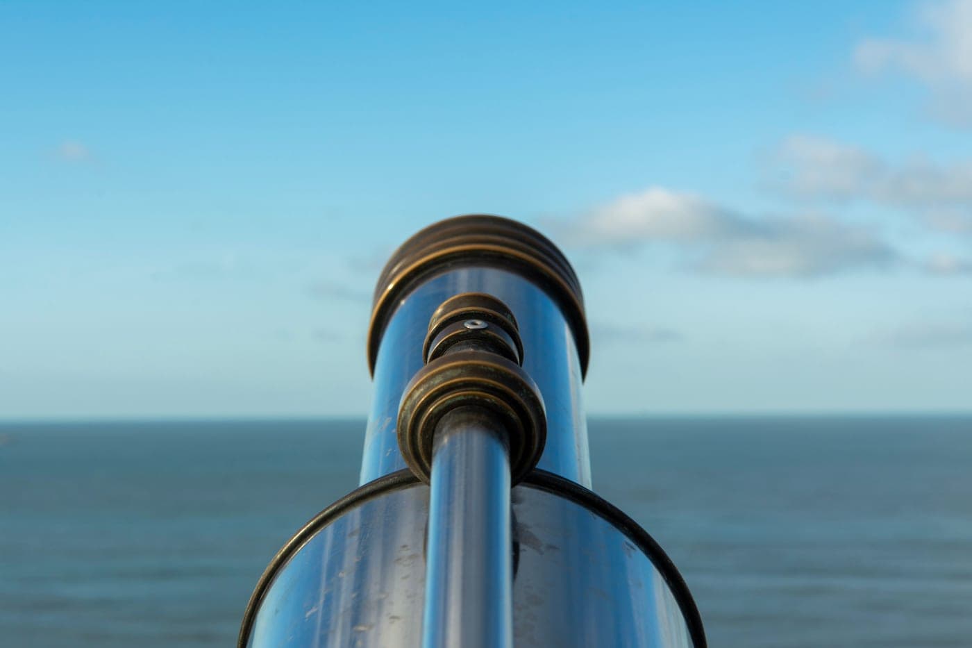A telescope on a seafront looking out over open water